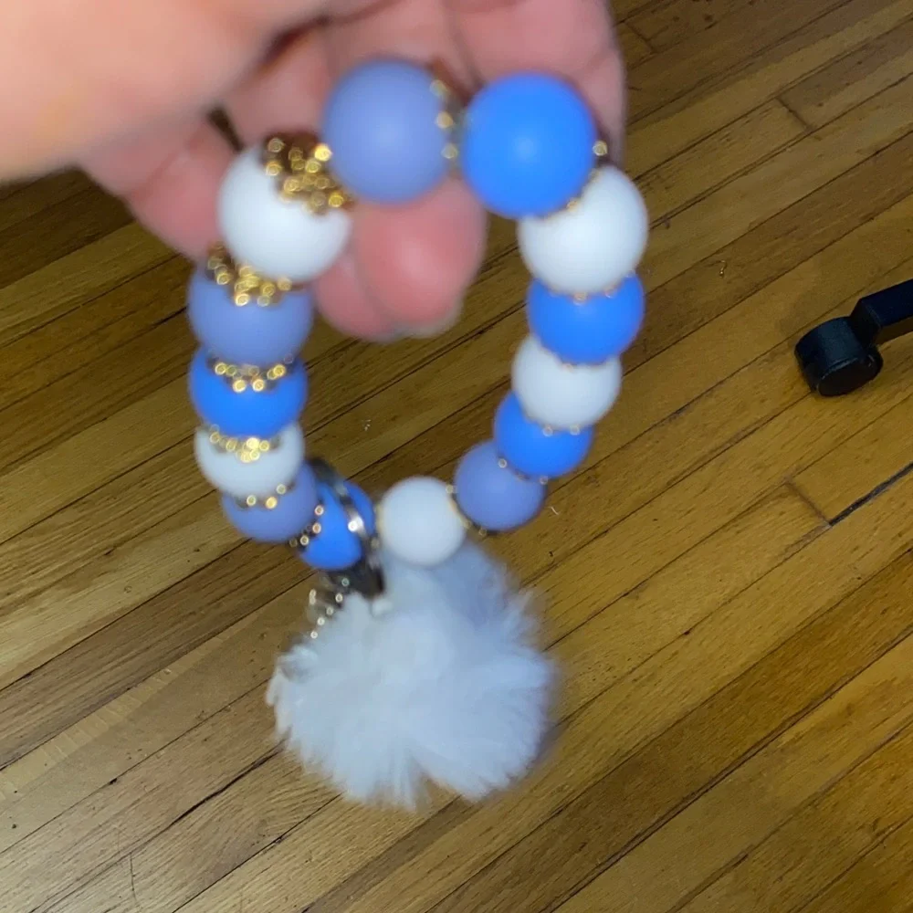 Blue and white bracelet keychain with white pom-pom